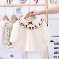 Baby girl apricot cotton shirt with strawberry embroidery, puff sleeves, and front bow patch