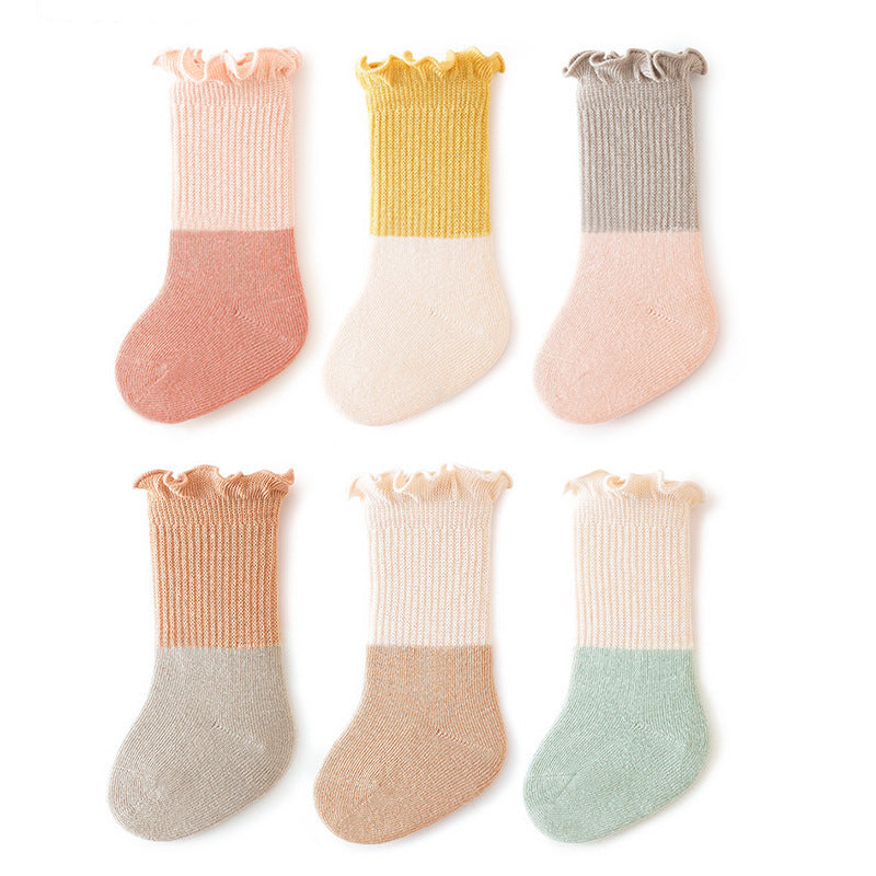 Unisex baby patchwork ruffle crew socks in bright colors, made of a soft cotton blend.