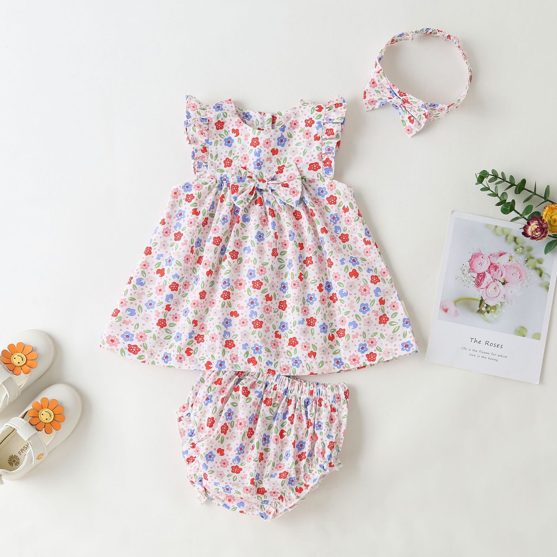 Pink floral baby girl sleeveless bodysuit dress with bow tie detail and round collar