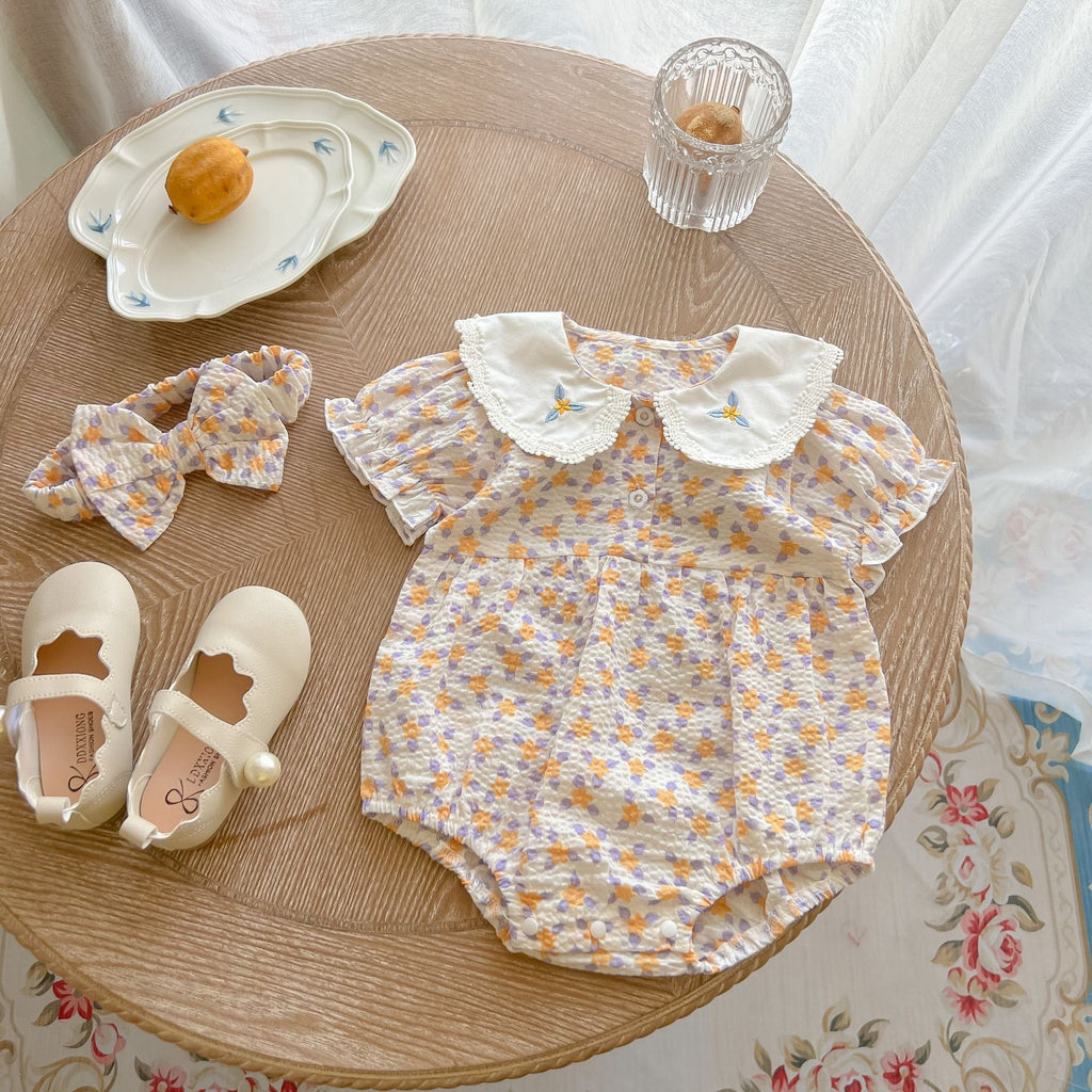 Yellow floral print baby girl bodysuit with an embroidered doll collar made of soft cotton