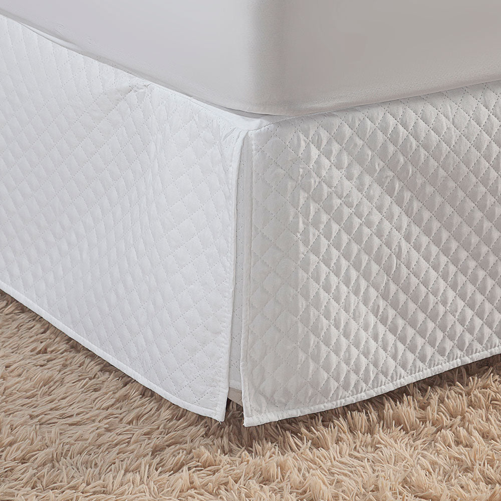 Quilted white full bed skirt with tailored corner pleats covering a standard bedroom box spring — view 5
