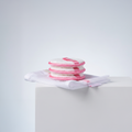 Three reusable microfibre makeup remover puffs with a complimentary mesh laundry wash bag.
