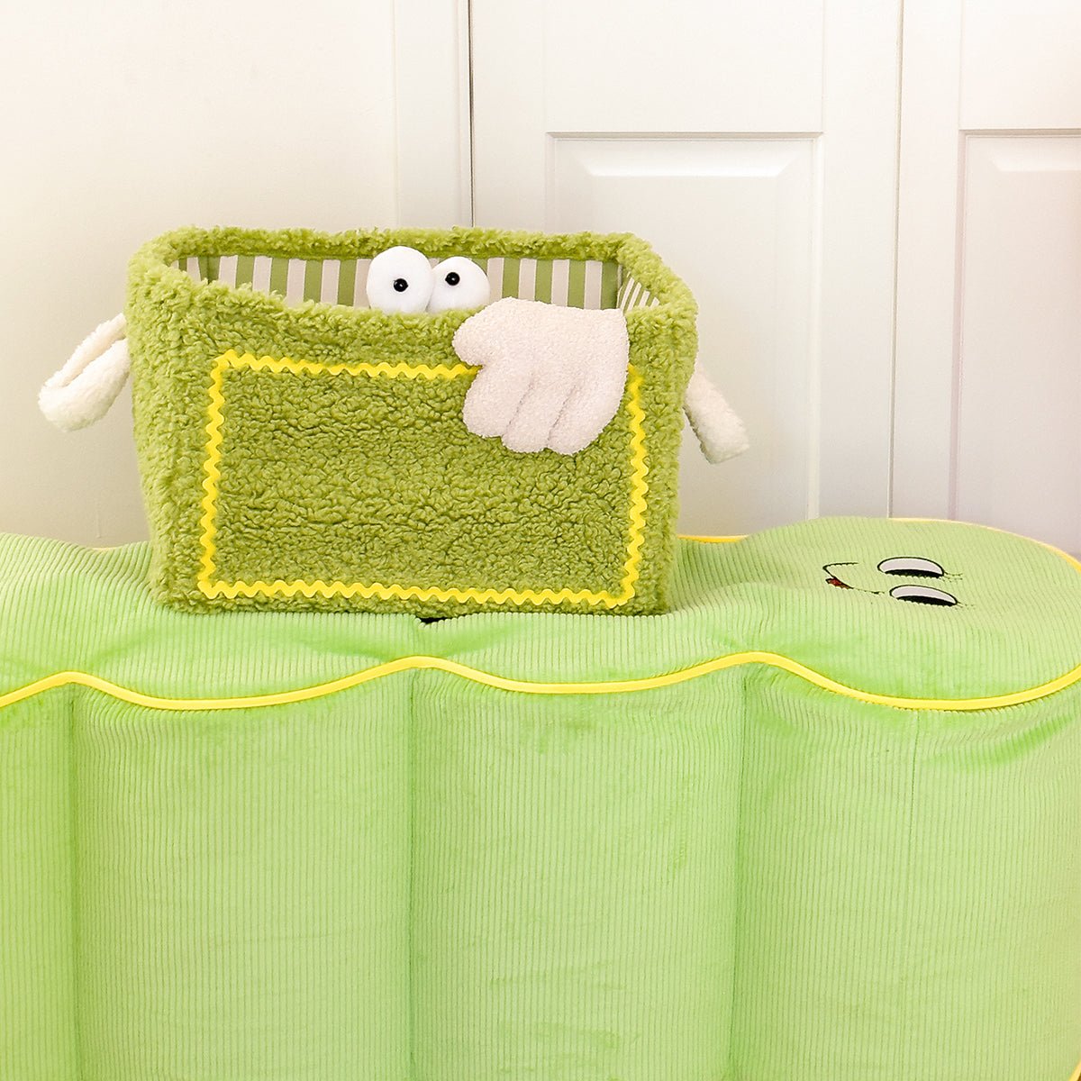 Quirky monster striped storage basket in soft velvet, perfect for organizing kids playroom toys.