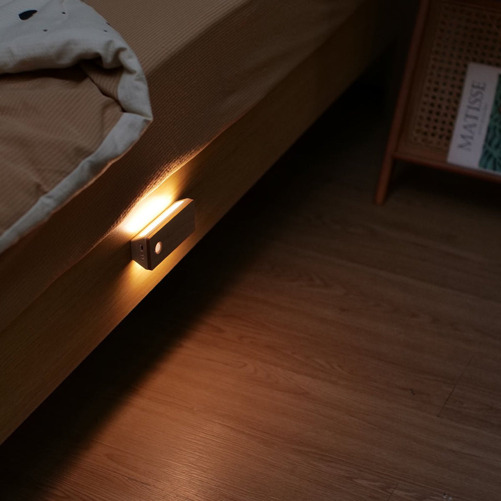 Rechargeable wooden wall night light with magnetic mount emitting a warm LED glow indoors — view 2
