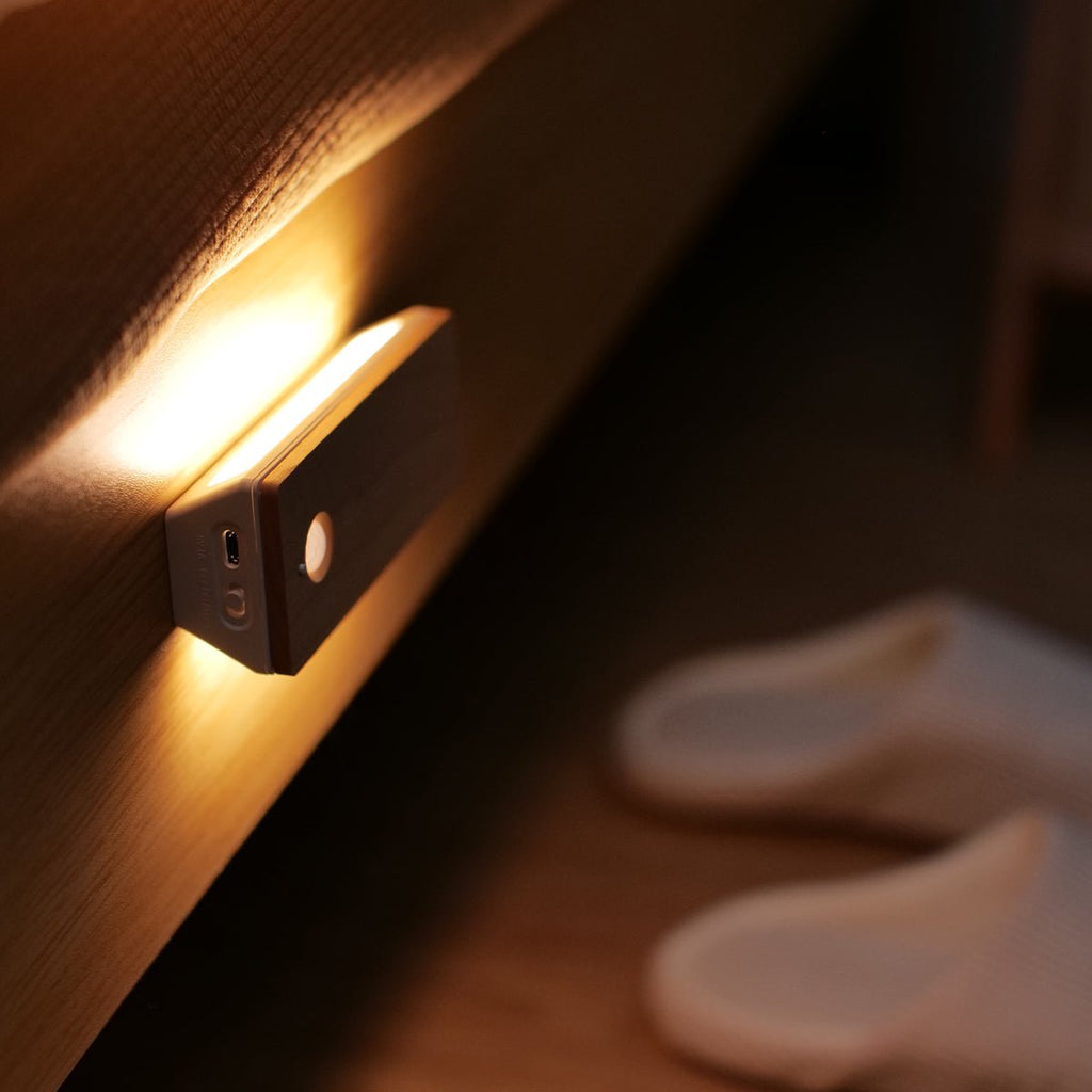 Rechargeable wooden wall night light with magnetic mount emitting a warm LED glow indoors — view 3