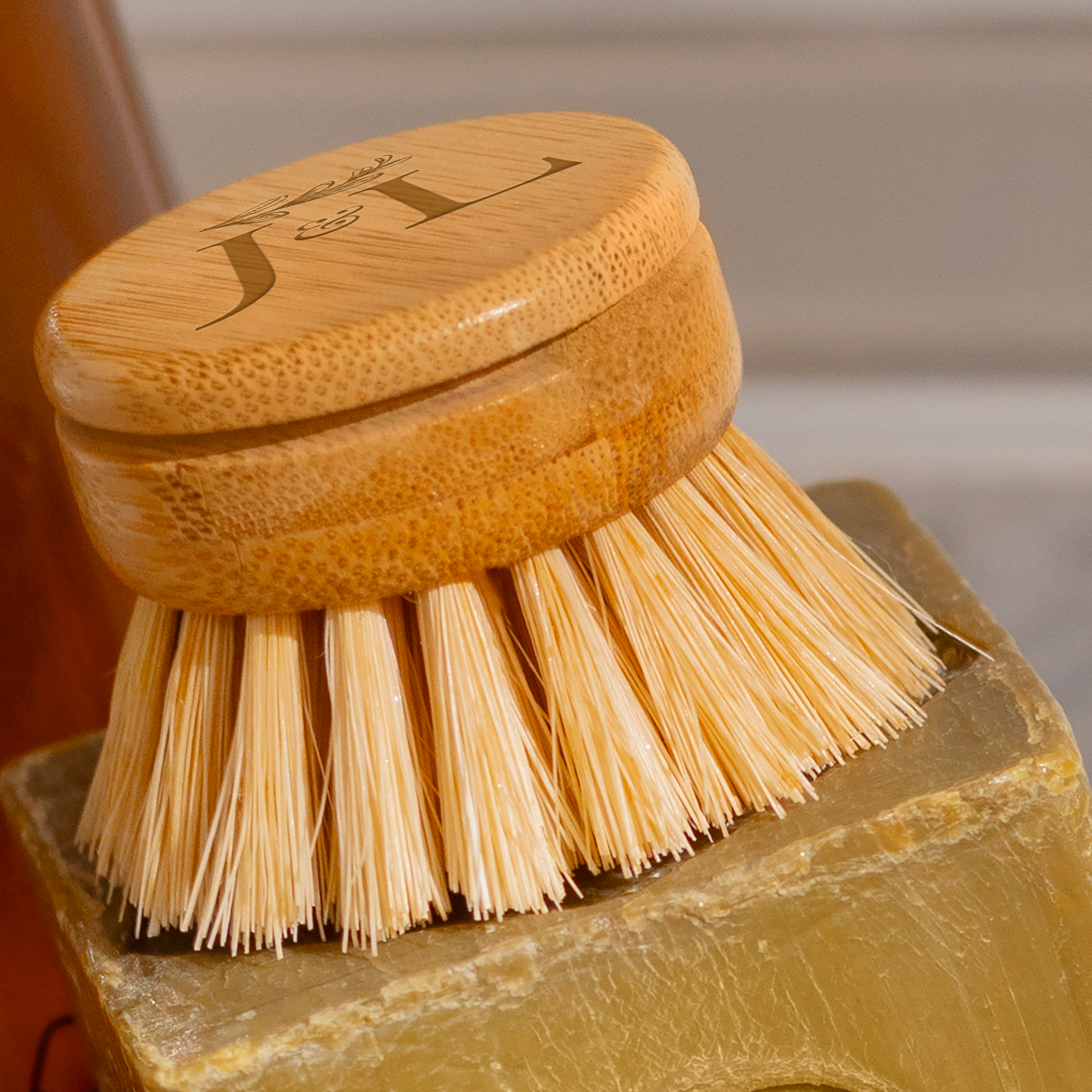 Bamboo long handle dish brush with natural sisal bristles on a kitchen counter — view 2