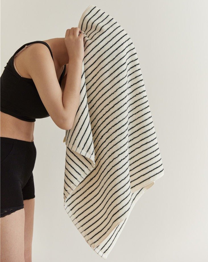 Retro style striped organic combed cotton bath towel folded elegantly in a modern bathroom setting — view 2