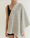 Retro style striped organic combed cotton bath towel folded elegantly in a modern bathroom setting