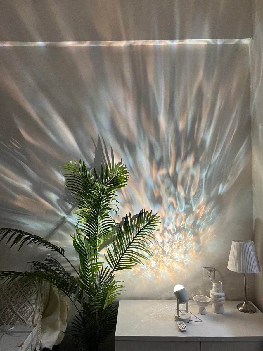 Modern aluminum ripple projector table lamp casting dynamic ambient water ripples on a dark room wall — view 2