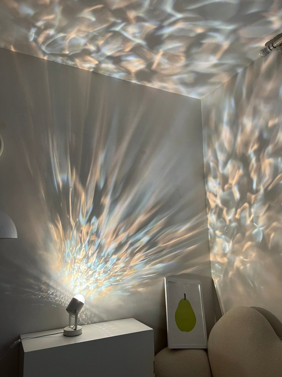 Modern aluminum ripple projector table lamp casting dynamic ambient water ripples on a dark room wall — view 3