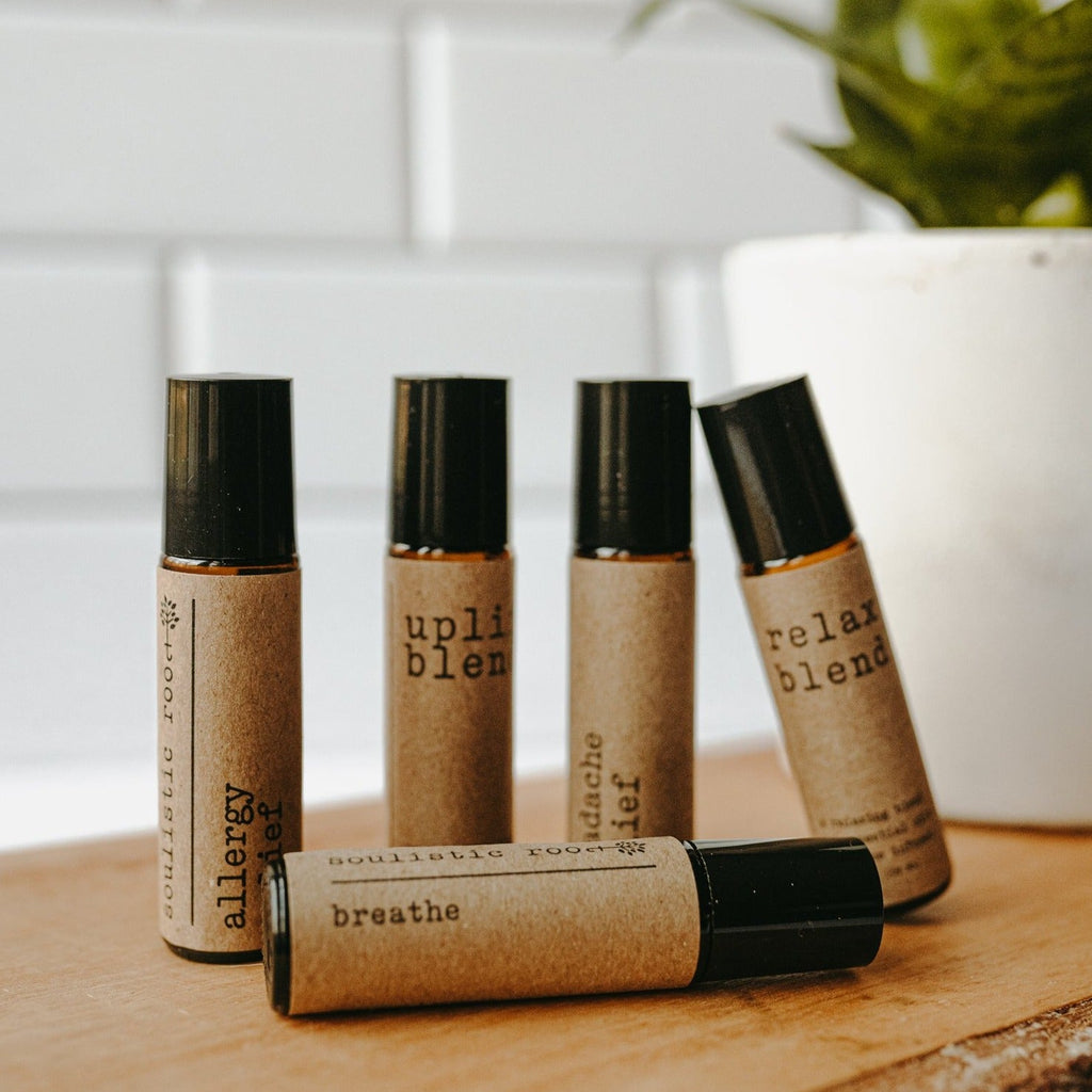 Collection of essential oil rollers with distinct blends infused with crystals in clear glass bottles — view 4