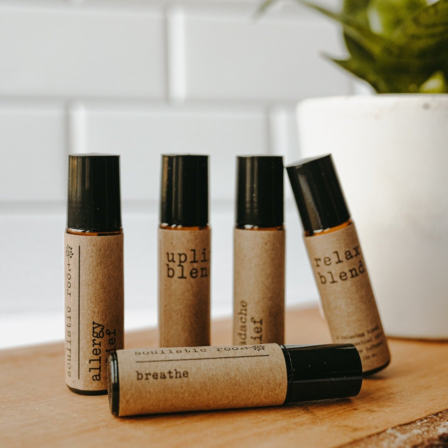 Collection of essential oil rollers with distinct blends infused with crystals in clear glass bottles — view 4