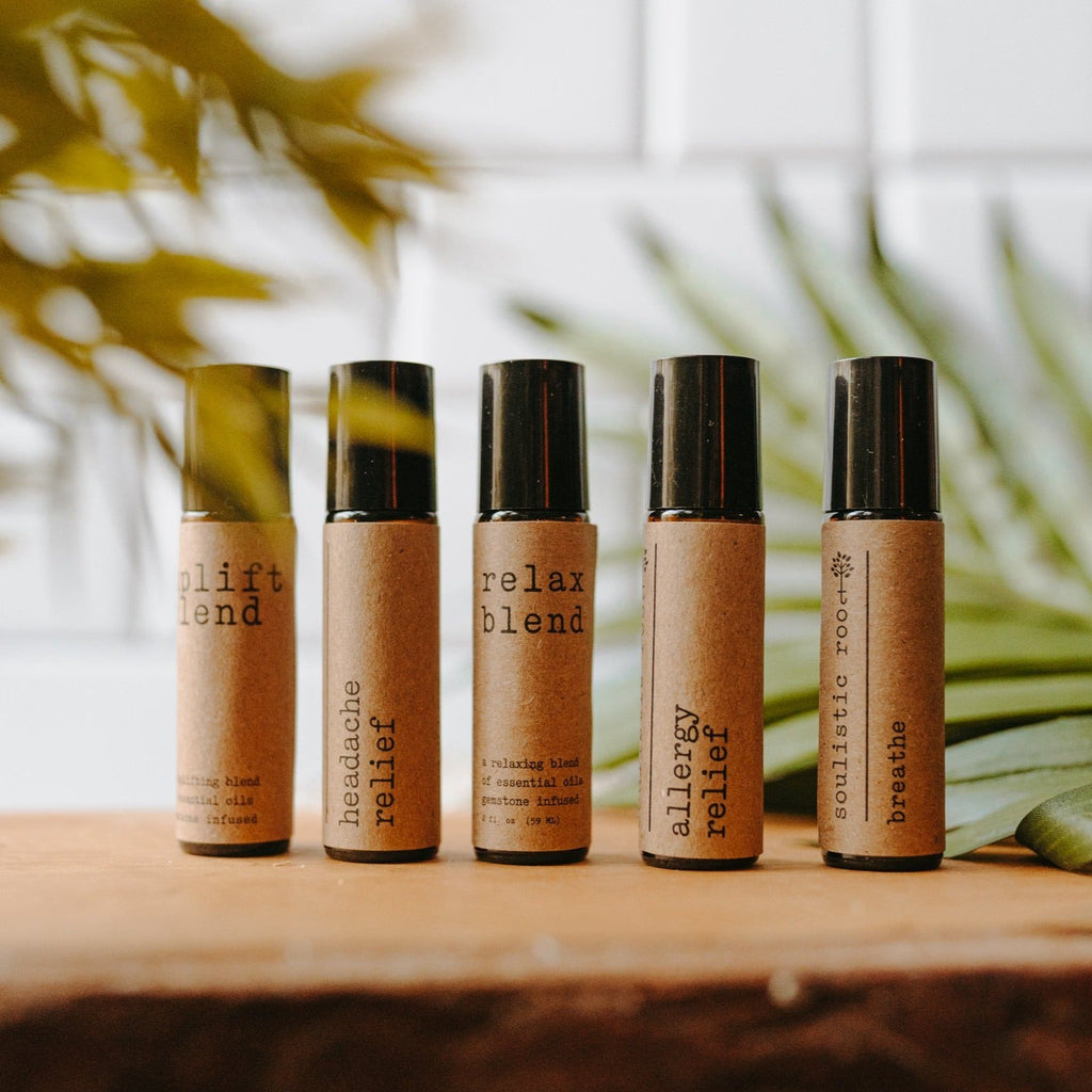 Collection of essential oil rollers with distinct blends infused with crystals in clear glass bottles — view 3