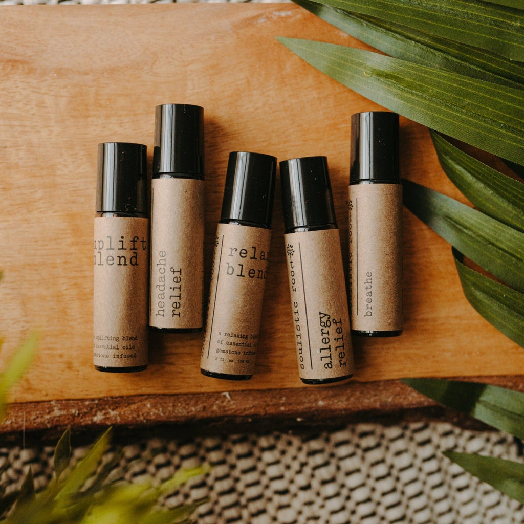 Collection of essential oil rollers with distinct blends infused with crystals in clear glass bottles — view 2