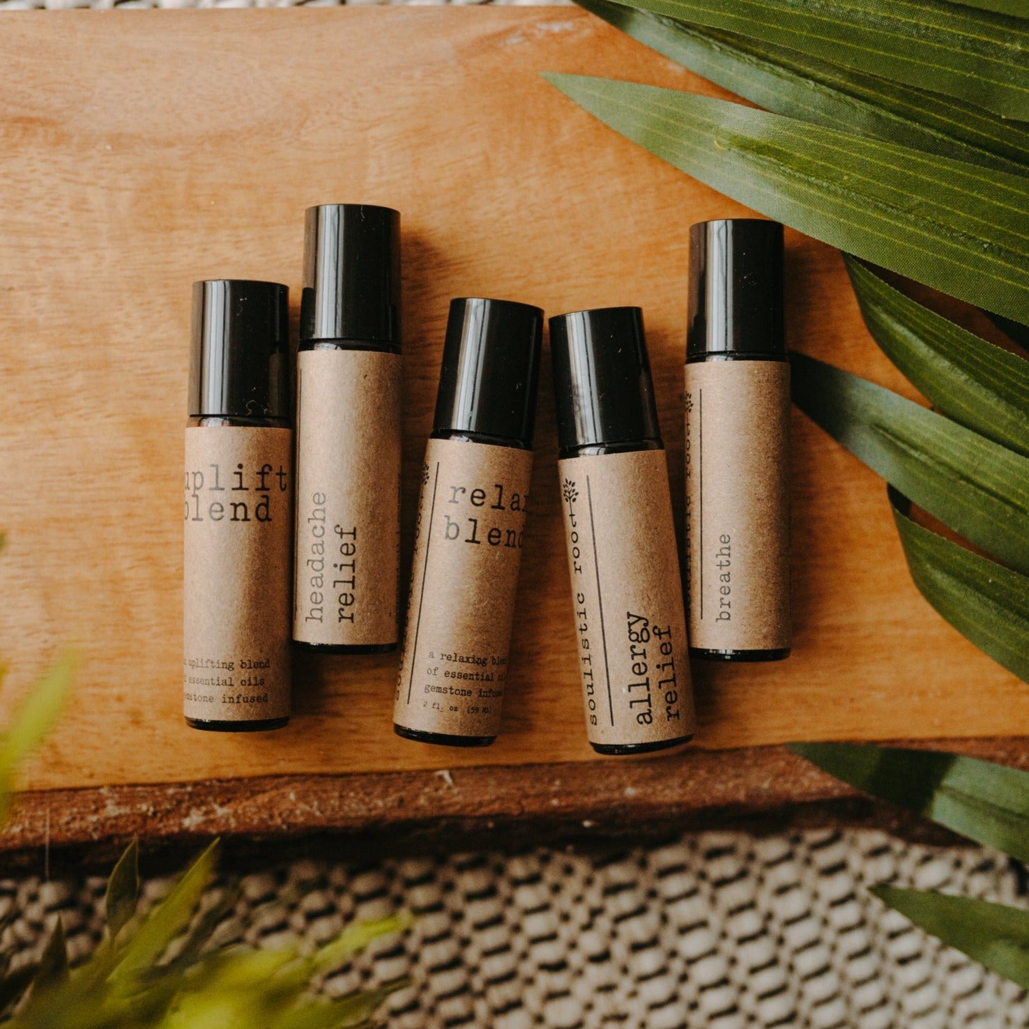 Collection of essential oil rollers with distinct blends infused with crystals in clear glass bottles — view 2