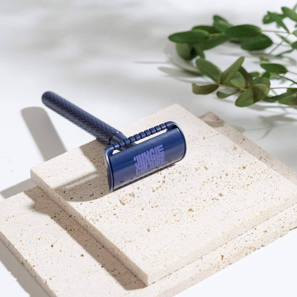 Textured diamond grip metal safety razor with ten replacement blades on a bathroom counter — view 5
