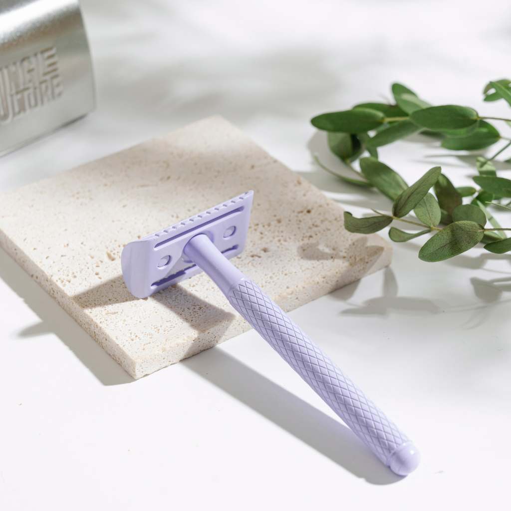 Textured diamond grip metal safety razor with ten replacement blades on a bathroom counter — view 2