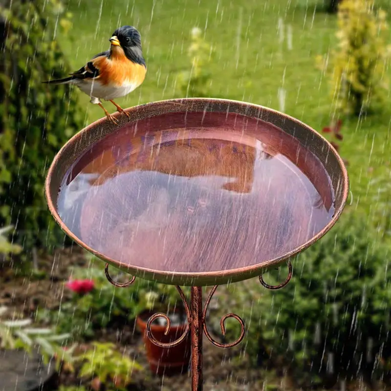 Vintage metal bird bath with copper finish on a sturdy pedestal stand in an outdoor garden — view 5