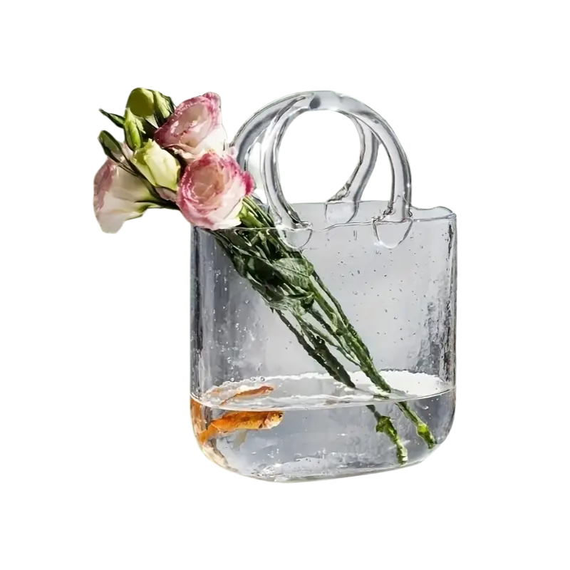 Clear transparent glass handbag vase doubling as a desktop fish tank and decorative hydroponic plant container