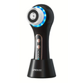 Black rechargeable facial cleansing brush with five interchangeable heads and stand on a clear background