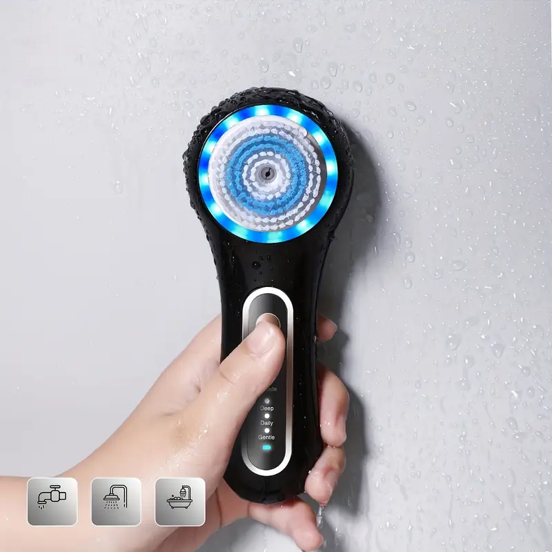Black rechargeable facial cleansing brush with five interchangeable heads and stand on a clear background — view 3