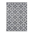 Outdoor reversible patio mat with large geometric pattern made of braided polypropylene for camping