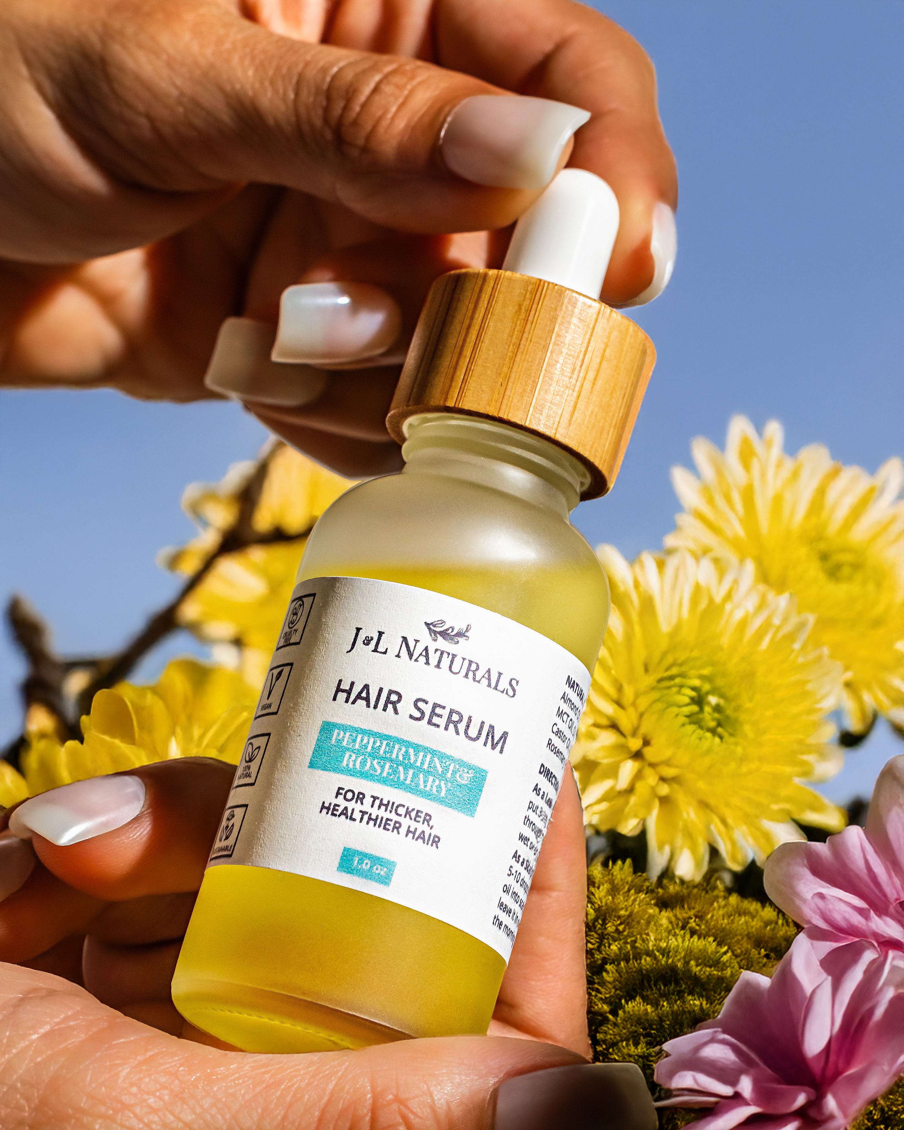 Vegan hair serum in a one ounce glass dropper bottle with natural botanical oils — view 2