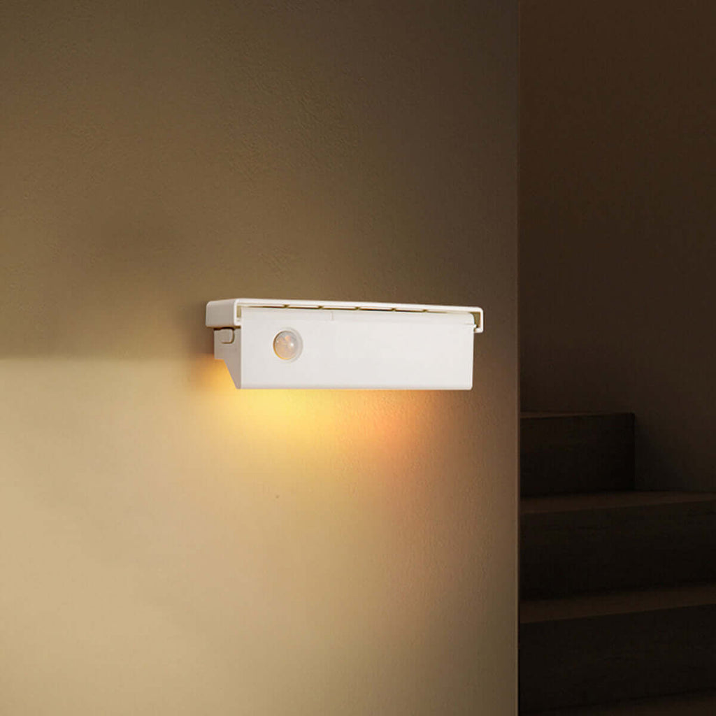 Smart motion magnetic wall light emitting a warm white glow mounted on a modern wall