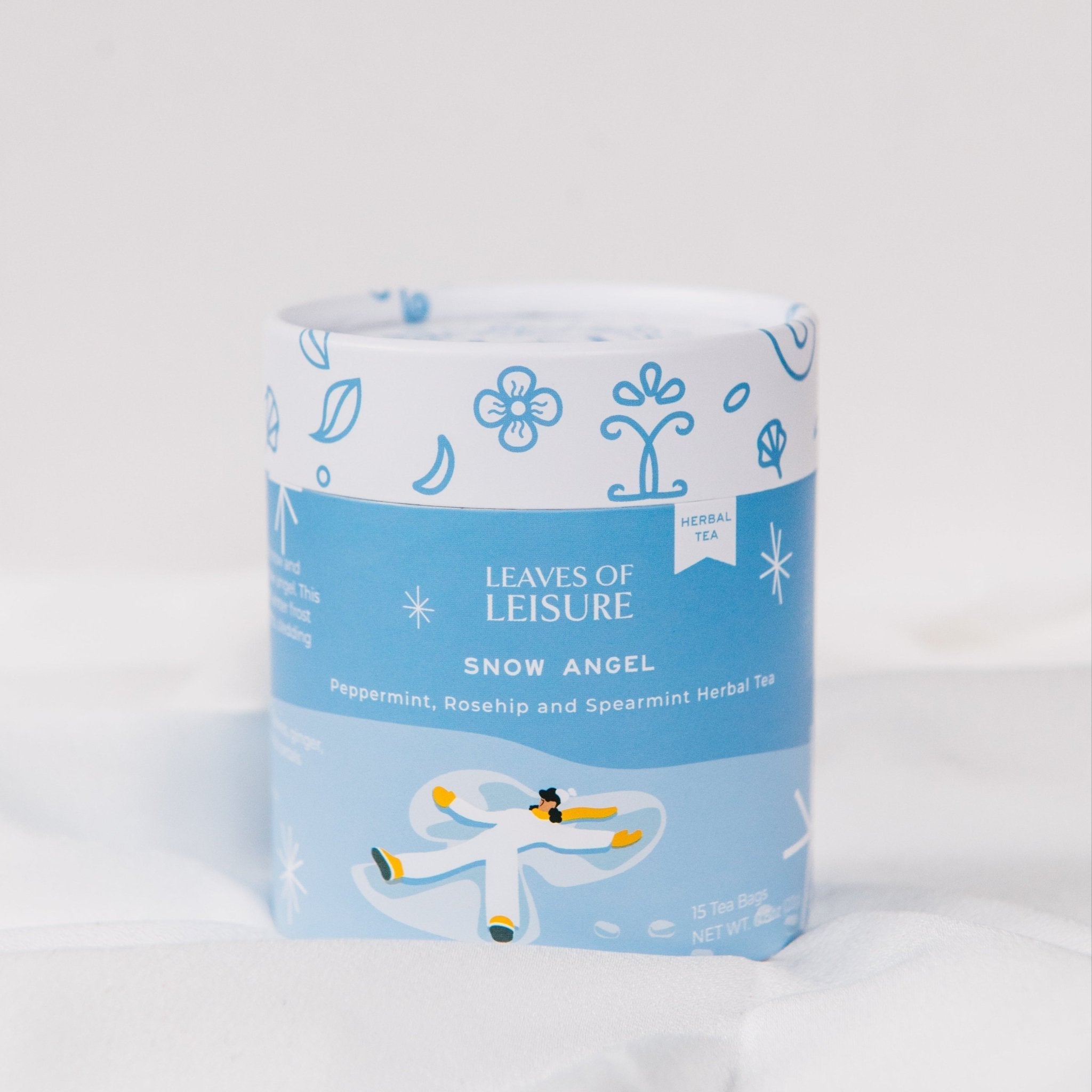 Snow Angel herbal tea blend in a reusable keepsake paper canister with compostable mesh bags