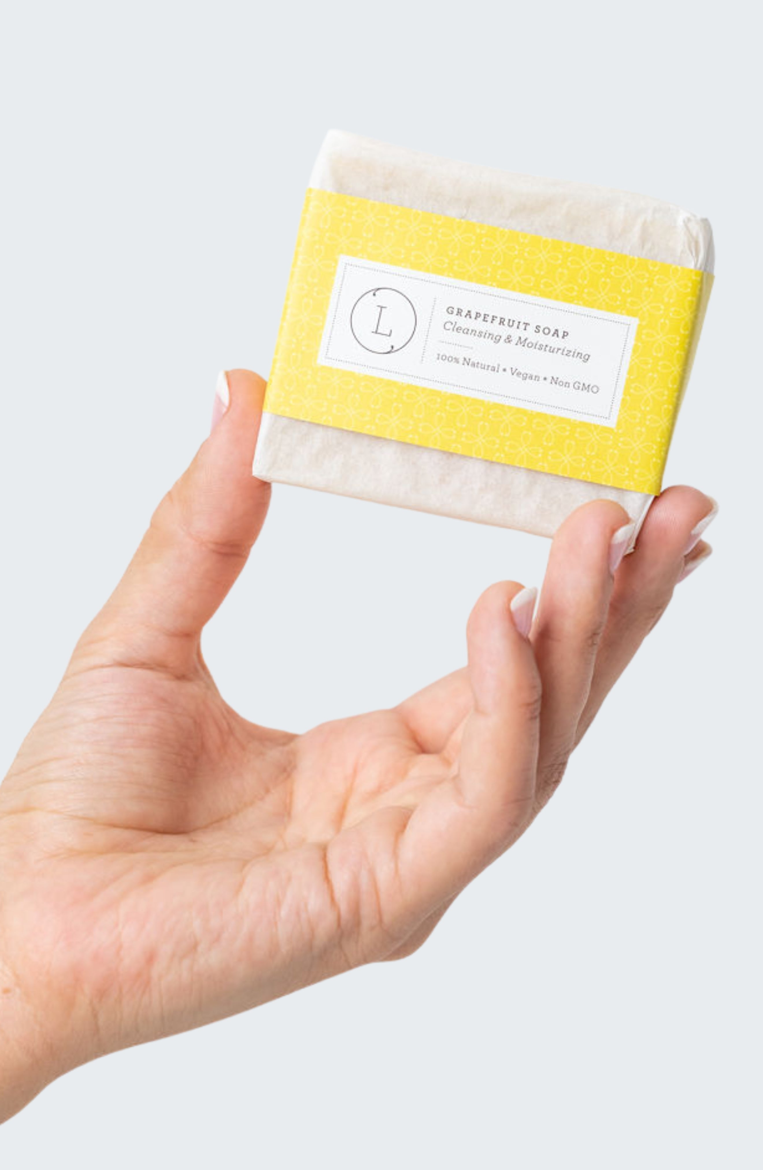 Two natural pink grapefruit handmade soap bars packed in a rustic cotton drawstring bag — view 2