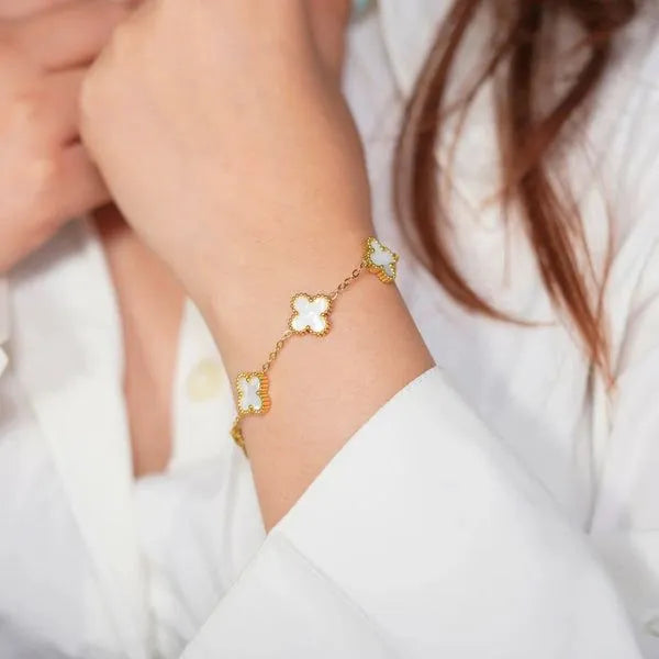 White four-leaf clover lucky charm bracelet on a minimalist adjustable gold-tone chain — view 5