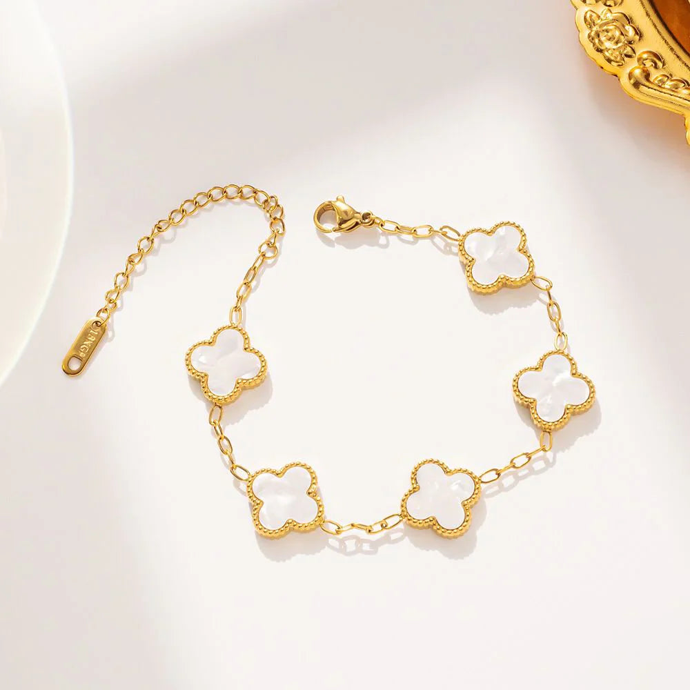 White four-leaf clover lucky charm bracelet on a minimalist adjustable gold-tone chain — view 3