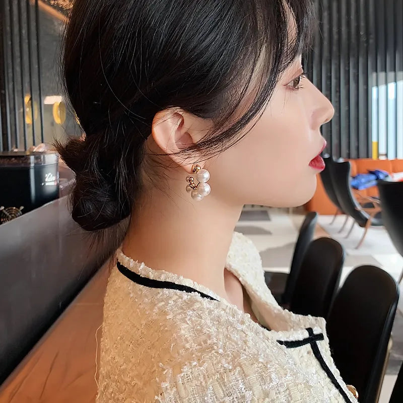 Elegant pearl cluster hoop earrings featuring a polished gold-plated finish and secure clasp design — view 2