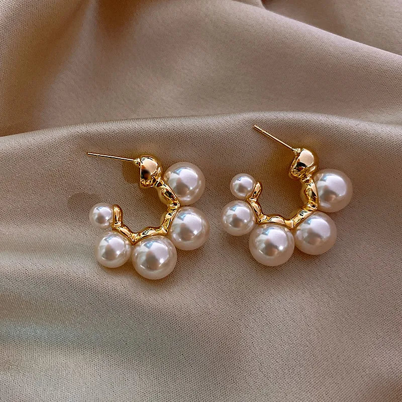 Elegant pearl cluster hoop earrings featuring a polished gold-plated finish and secure clasp design — view 3