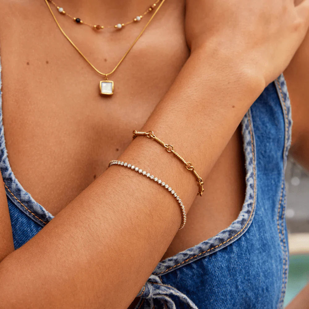 Elegant tennis bracelet with sparkling crystals set in a high-quality gold or silver-tone band. — view 4