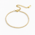 Elegant tennis bracelet with sparkling crystals set in a high-quality gold or silver-tone band.