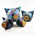 Handmade ceramic space piggy bank featuring a matte finish and a removable natural cork snout