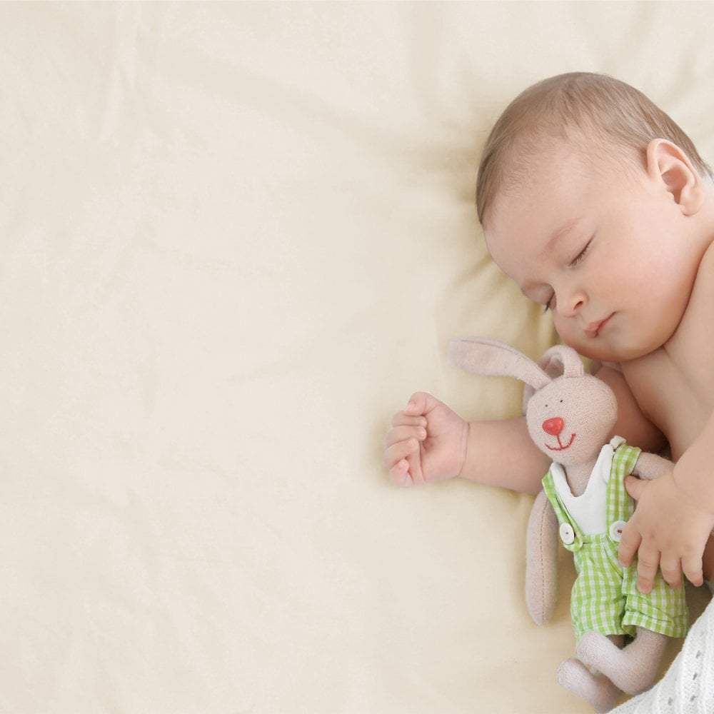 Soft white 100% cotton spacesaver cot fitted sheet with elasticized hem, covering a toddler mattress. — view 5