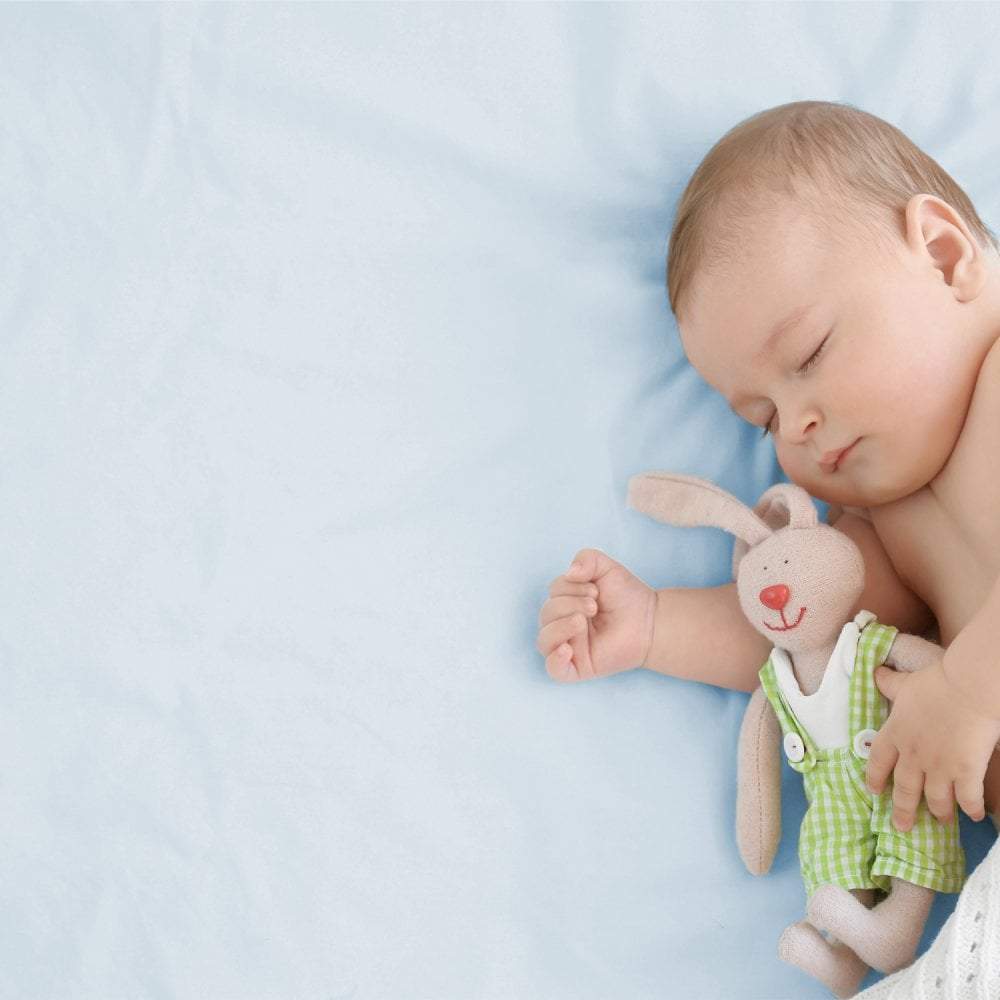 Soft white 100% cotton spacesaver cot fitted sheet with elasticized hem, covering a toddler mattress. — view 3