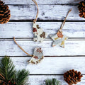 Set of three white polymer clay Christmas ornaments with gold silver and copper foil flakes.