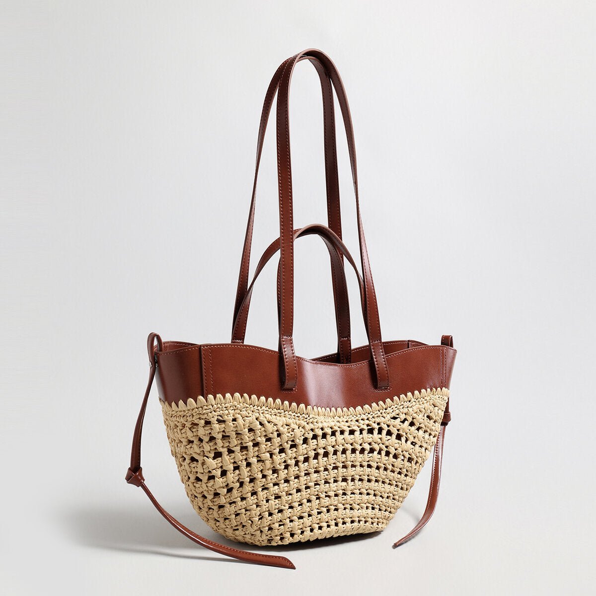 Handwoven natural straw and leather tote bag with multi-pocket interior and dual shoulder handles — view 3