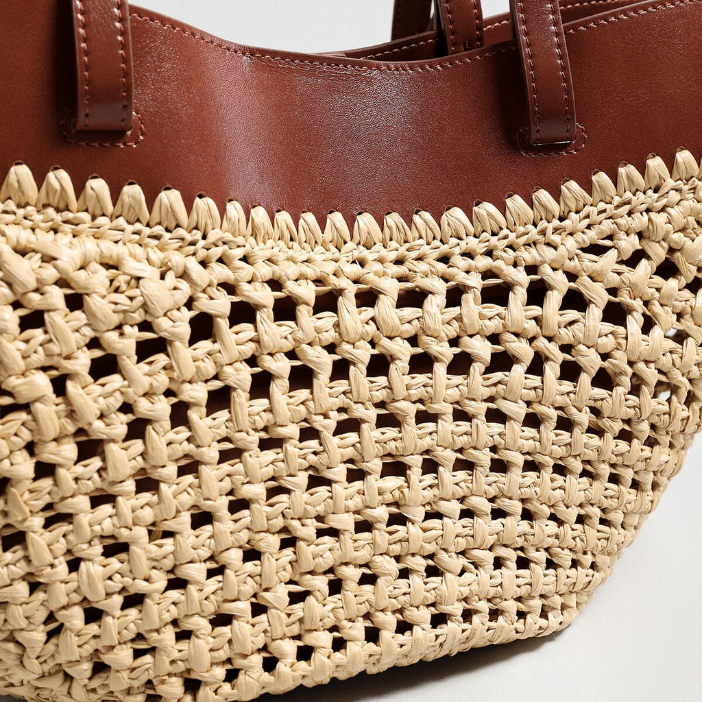 Handwoven natural straw and leather tote bag with multi-pocket interior and dual shoulder handles — view 4