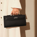 Structured saffiano leather top-handle clutch bag in elongated rectangular shape with silver turn-lock closure