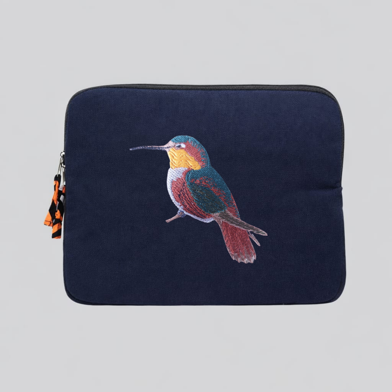 Handmade cotton canvas 13 inch laptop sleeve featuring detailed hummingbird embroidery in warm earthy tones