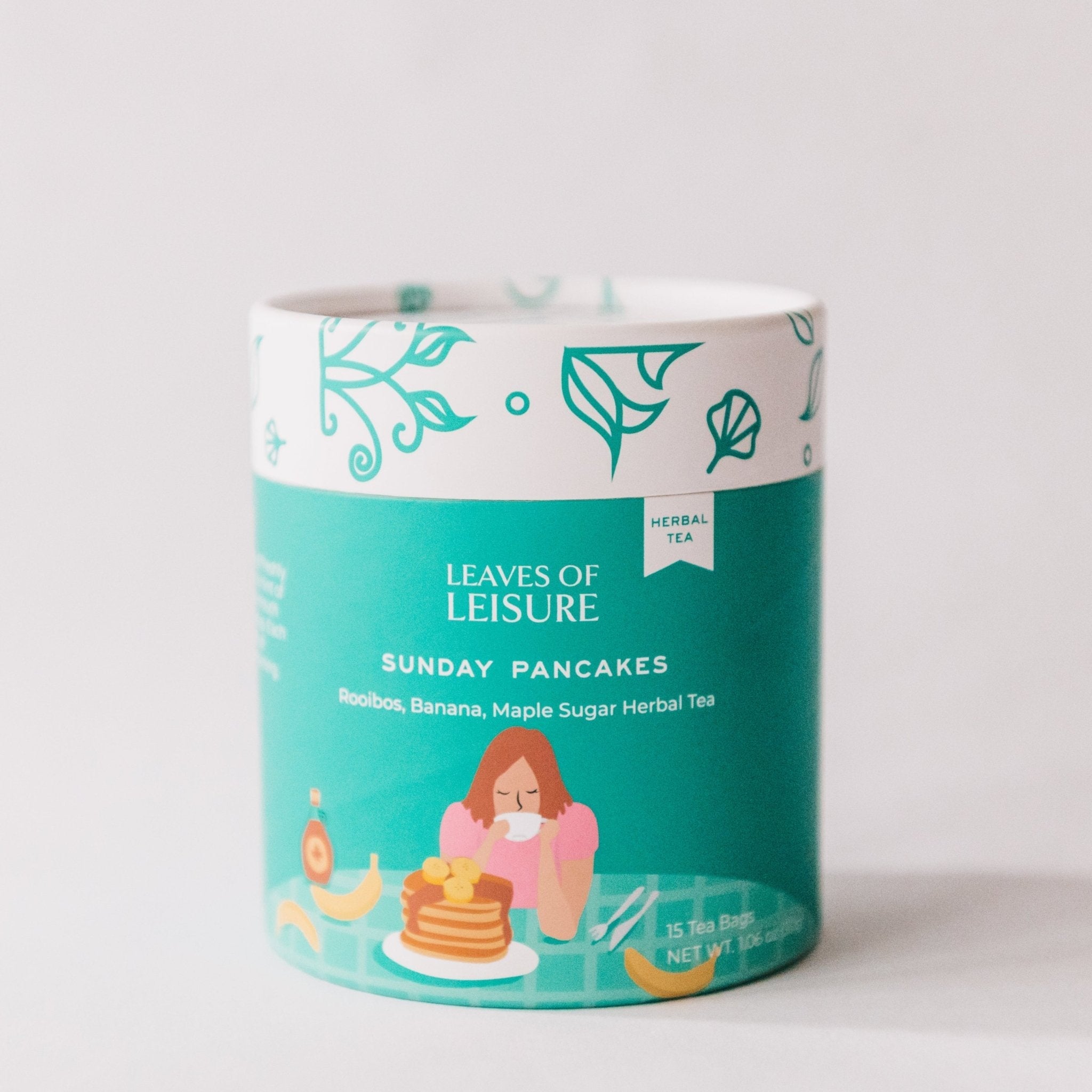 Sunday Pancakes herbal tea in a reusable paper canister alongside compostable corn mesh tea bags