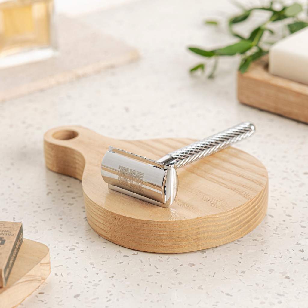 Textured diamond grip metal safety razor with ten replacement blades on a bathroom counter — view 4