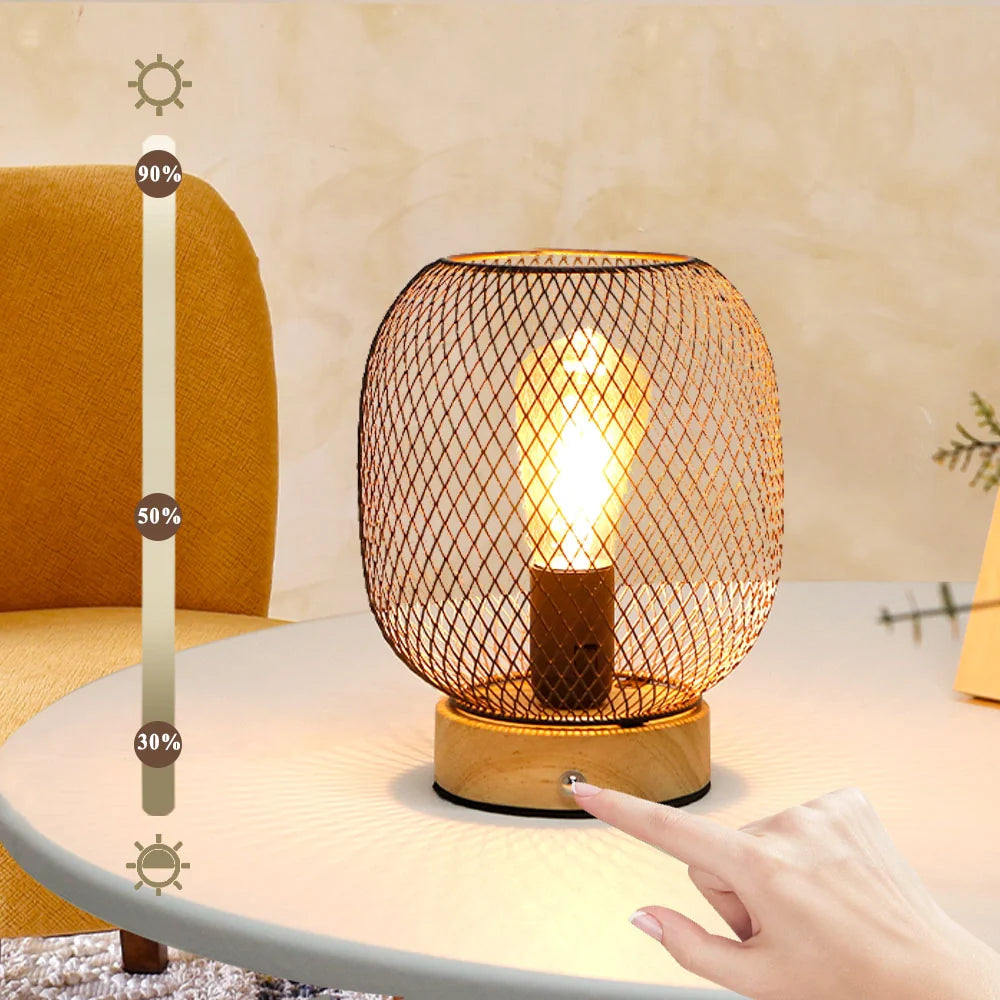 Bronze cage lantern style touch table lamp with wooden base and glowing golden LED bulb — view 2