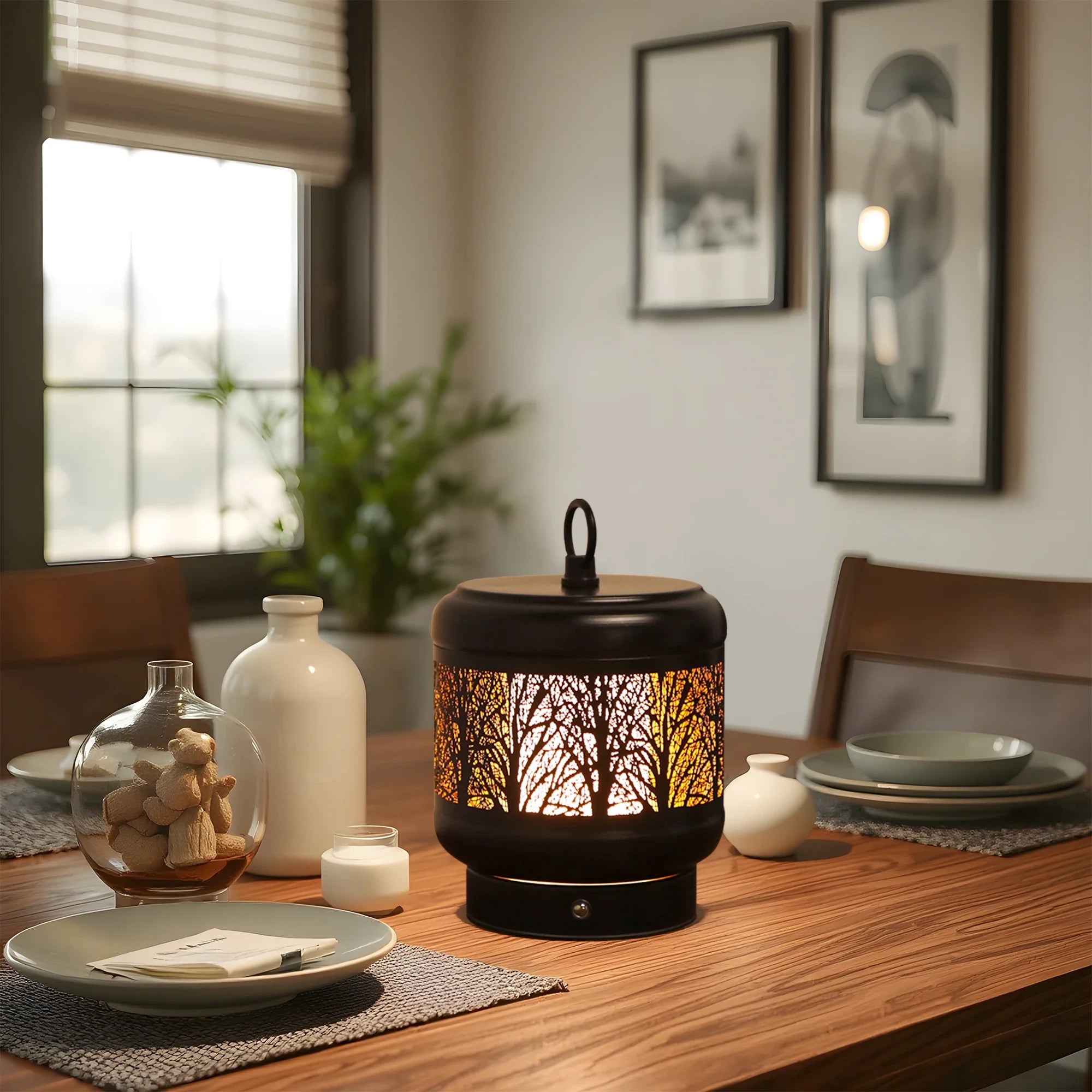 Rechargeable metal desk lamp with tree silhouette cutouts glowing in warm light on a table — view 4