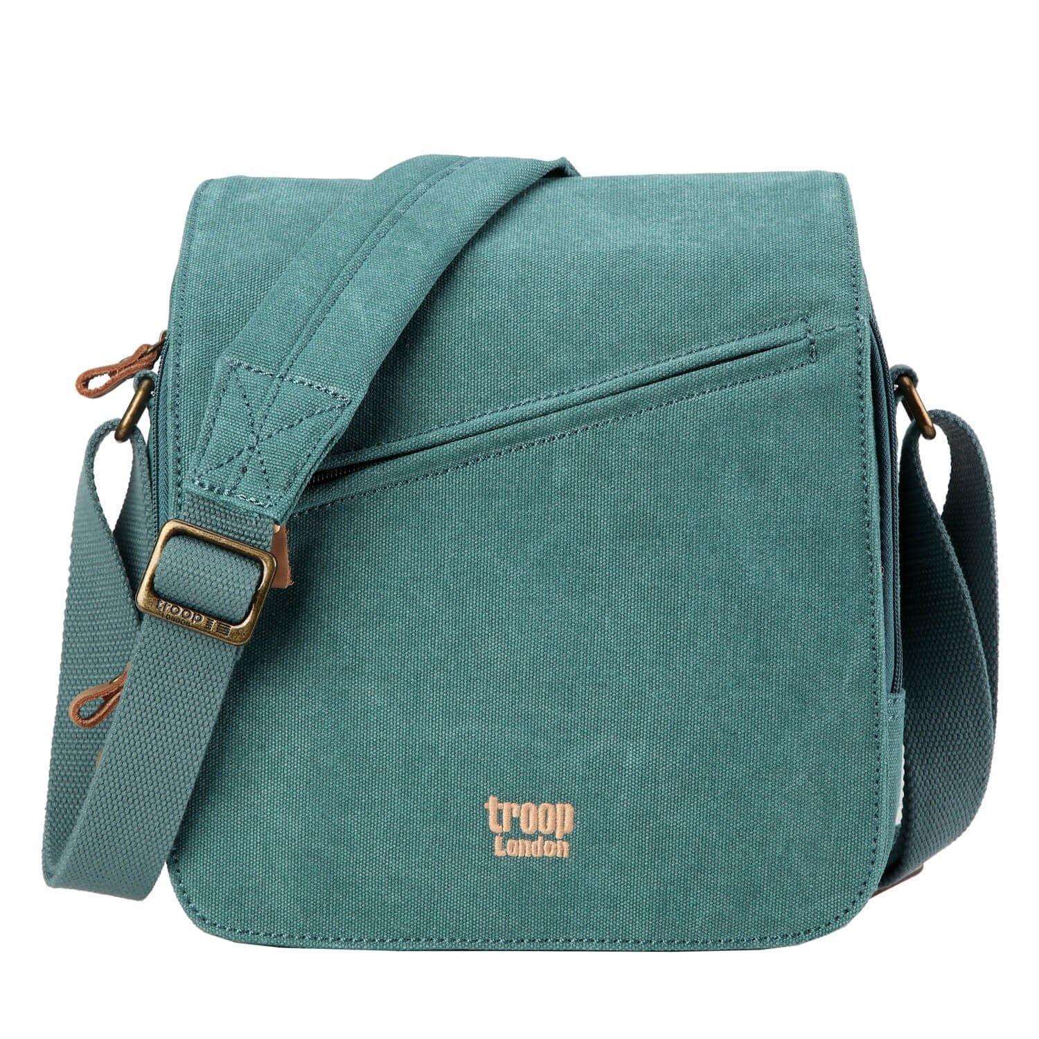 Stonewashed canvas flap crossbody bag with genuine leather trimmings and adjustable padded shoulder strap.