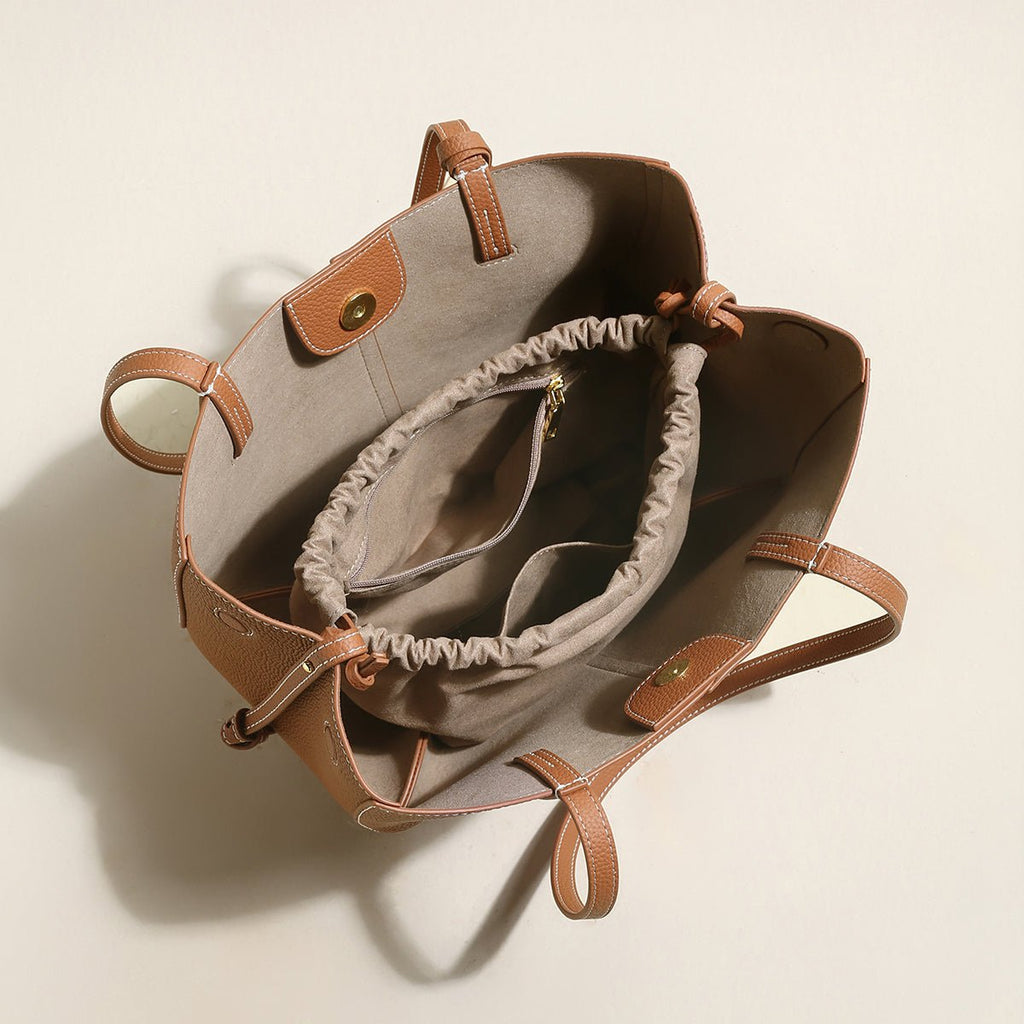 Pebbled leather trapezoid tote bag featuring a sculptural front knot detail and long shoulder straps — view 5